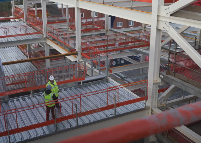 Elland Steel team discussing University of Salford SEE building