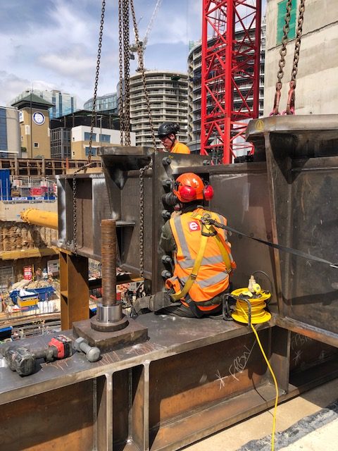 Installers connecting the tower crane modules together with bolts