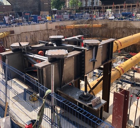 Tower crane base installed partly into concrete frame